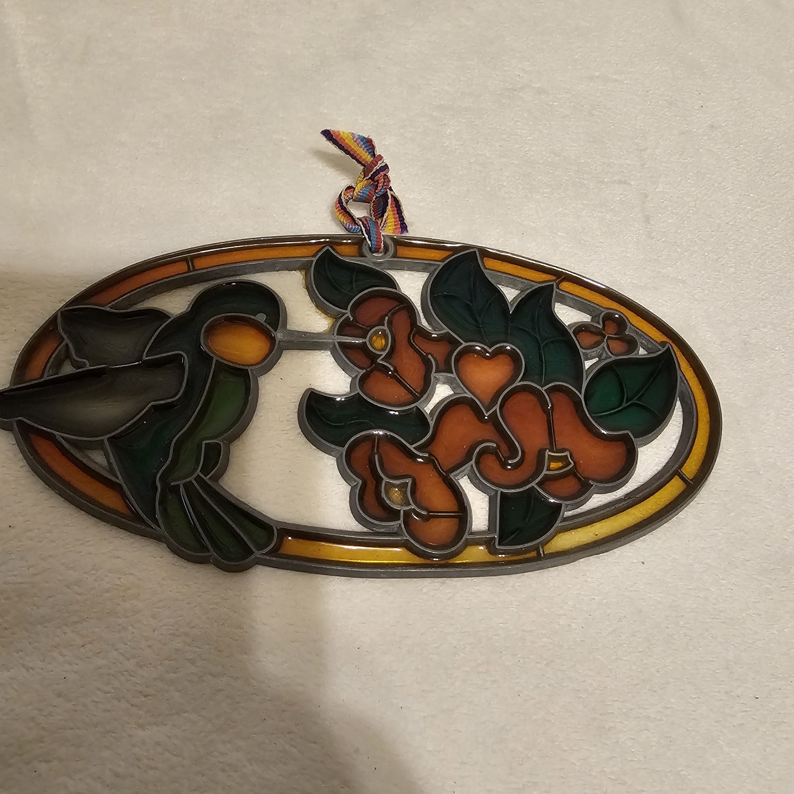 Hummingbird And Flowers Oval Sun Catcher. Plastic. 7.25×3.25x.025 In.