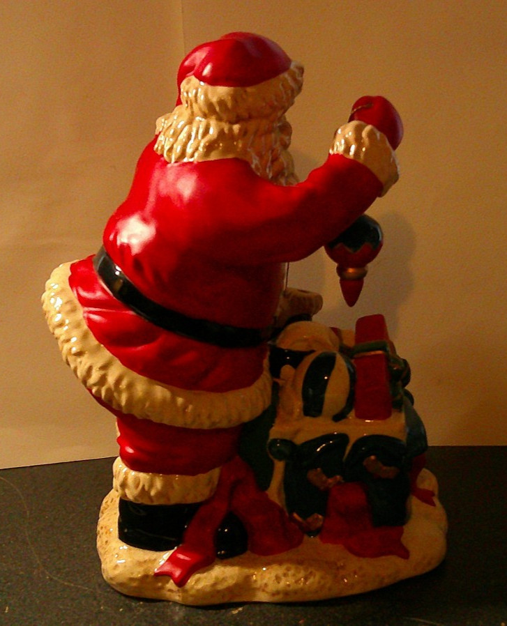 Santa Clause standing around presents with ornament 11 in. tall Ceramic figure