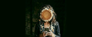 Une femme navigant sur son smartphone et entartée d'un gâteau.